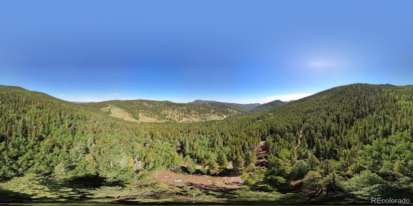 3450 Smith Hill Road Black Hawk, CO 80422 - Photo 23 of 26 a view of a mountain range with lush green forest