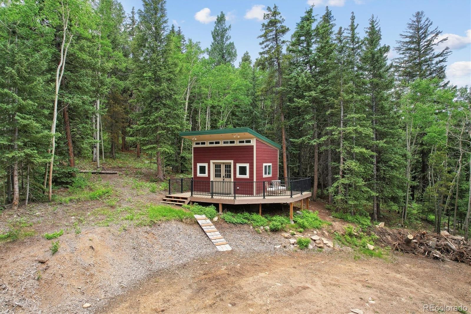 3450 Smith Hill Road Black Hawk, CO 80422 - Photo 8 of 26 a wooden deck with trees in the background