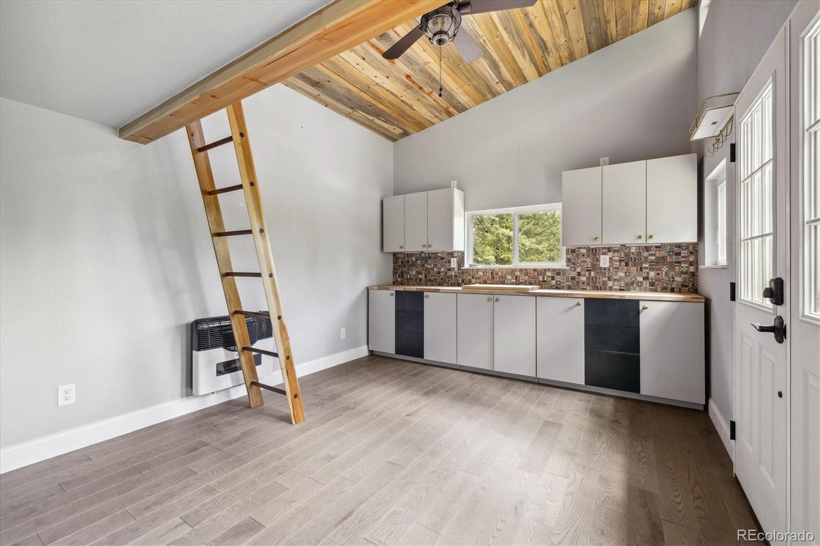 3450 Smith Hill Road Black Hawk, CO 80422 - Photo 10 of 26 a kitchen with stainless steel appliances granite countertop a stove a sink dishwasher and a refrigerator with wooden floor