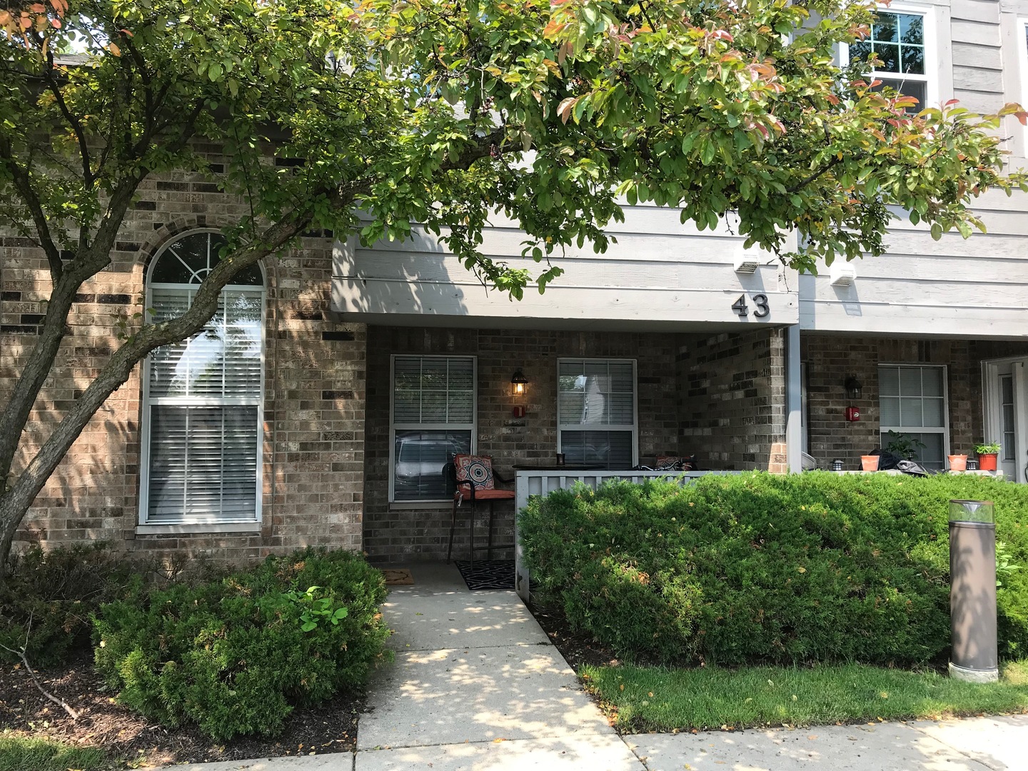 43 Foxcroft Road, Unit 123 Naperville, IL 60565 - Photo 1 of 11 a front view of a house with garden