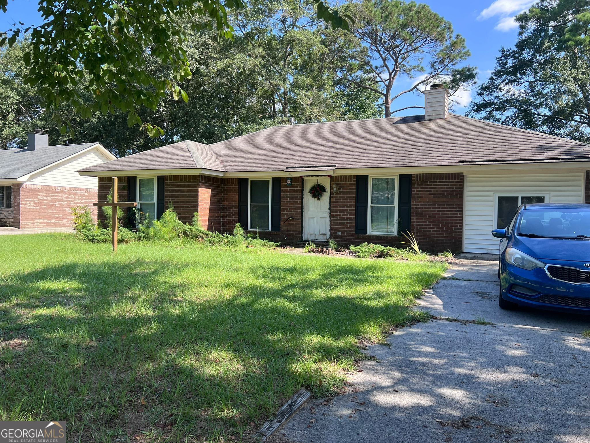 223 Melrose Place Rincon, GA 31326 - Photo 1 of 1 a front view of a house with garden