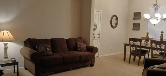 a living room with furniture a fireplace and a window