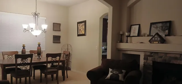 a view of a dining room with furniture and chandelier