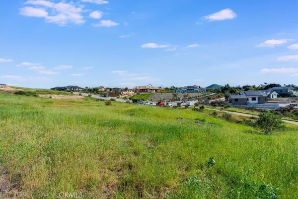 a view of a big yard with lots of green space and mountain view