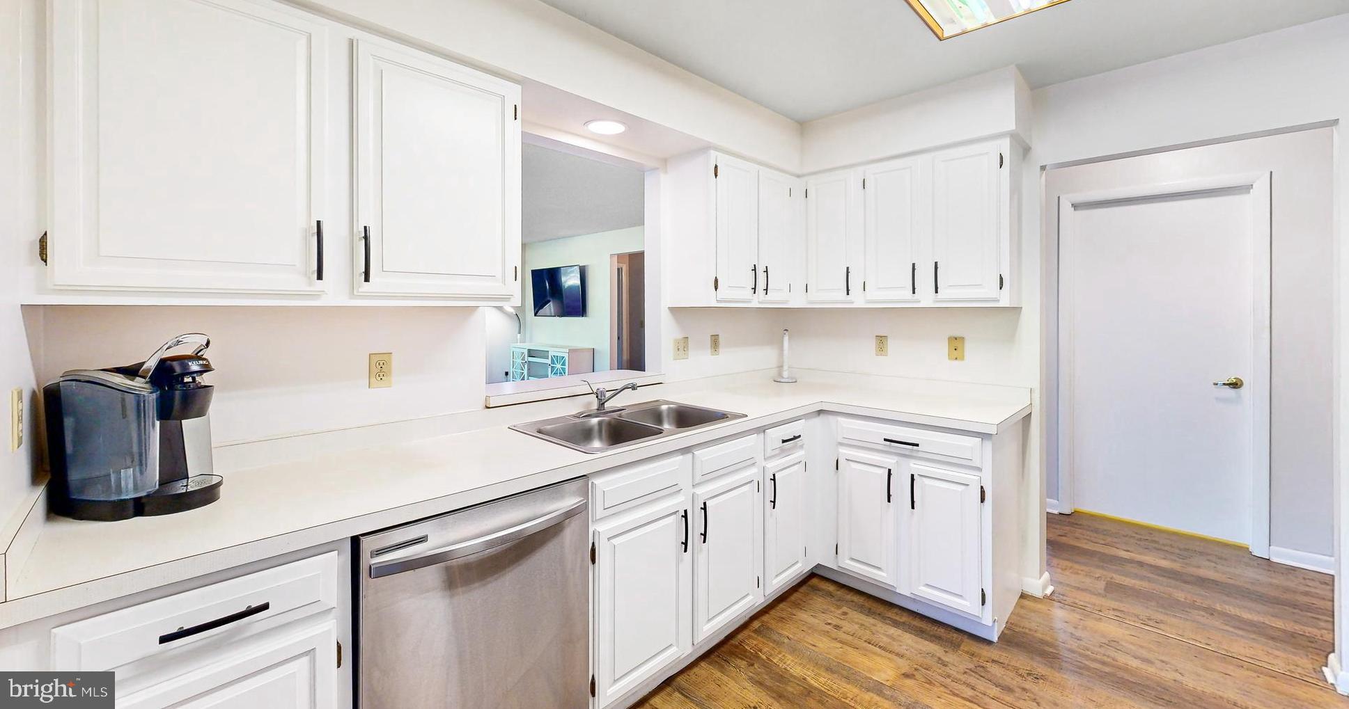33945 Middleton Circle, Unit 1 Lewes, DE 19958 - Photo 13 of 45 a kitchen with white cabinets and white appliances