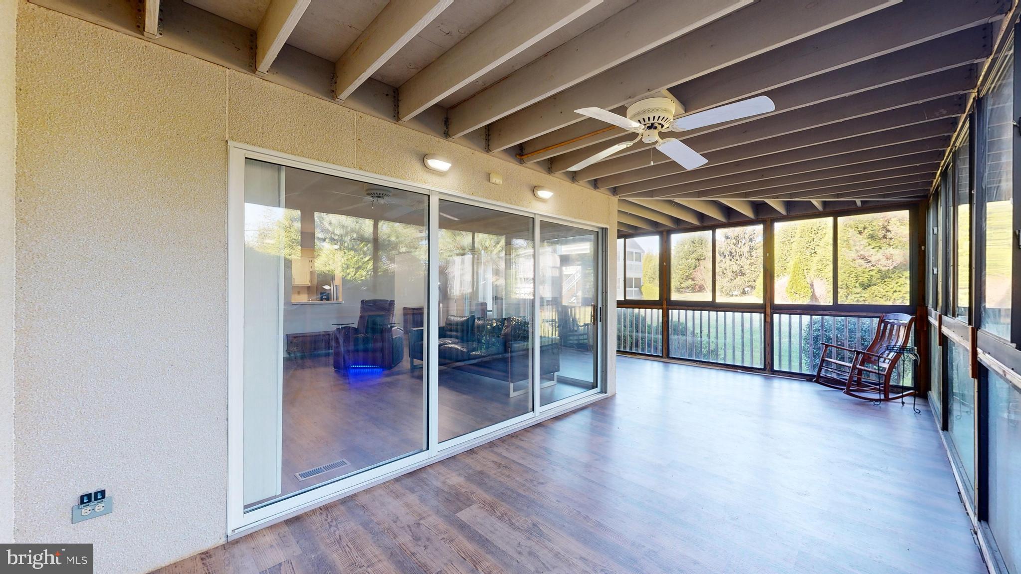 33945 Middleton Circle, Unit 1 Lewes, DE 19958 - Photo 14 of 45 a view of empty room with wooden floor and fan