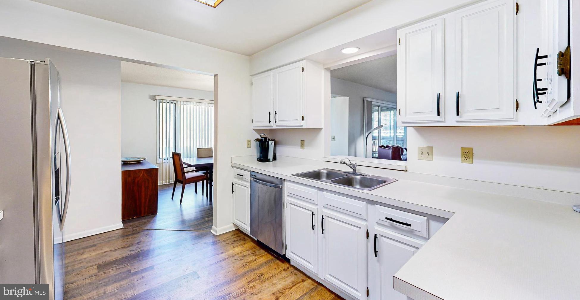 33945 Middleton Circle, Unit 1 Lewes, DE 19958 - Photo 15 of 45 a kitchen with cabinets and wooden floor