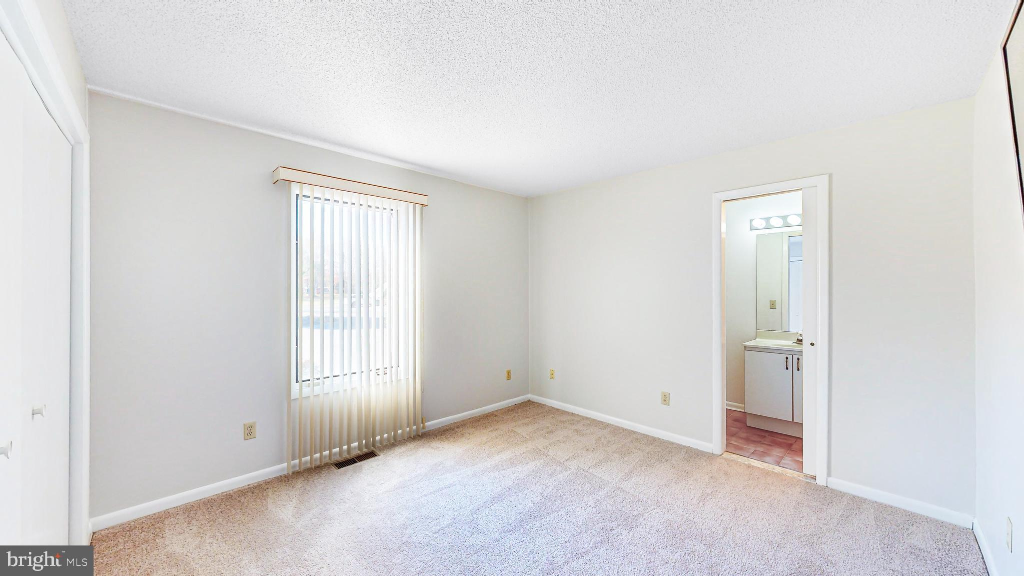 33945 Middleton Circle, Unit 1 Lewes, DE 19958 - Photo 21 of 45 an empty room with windows