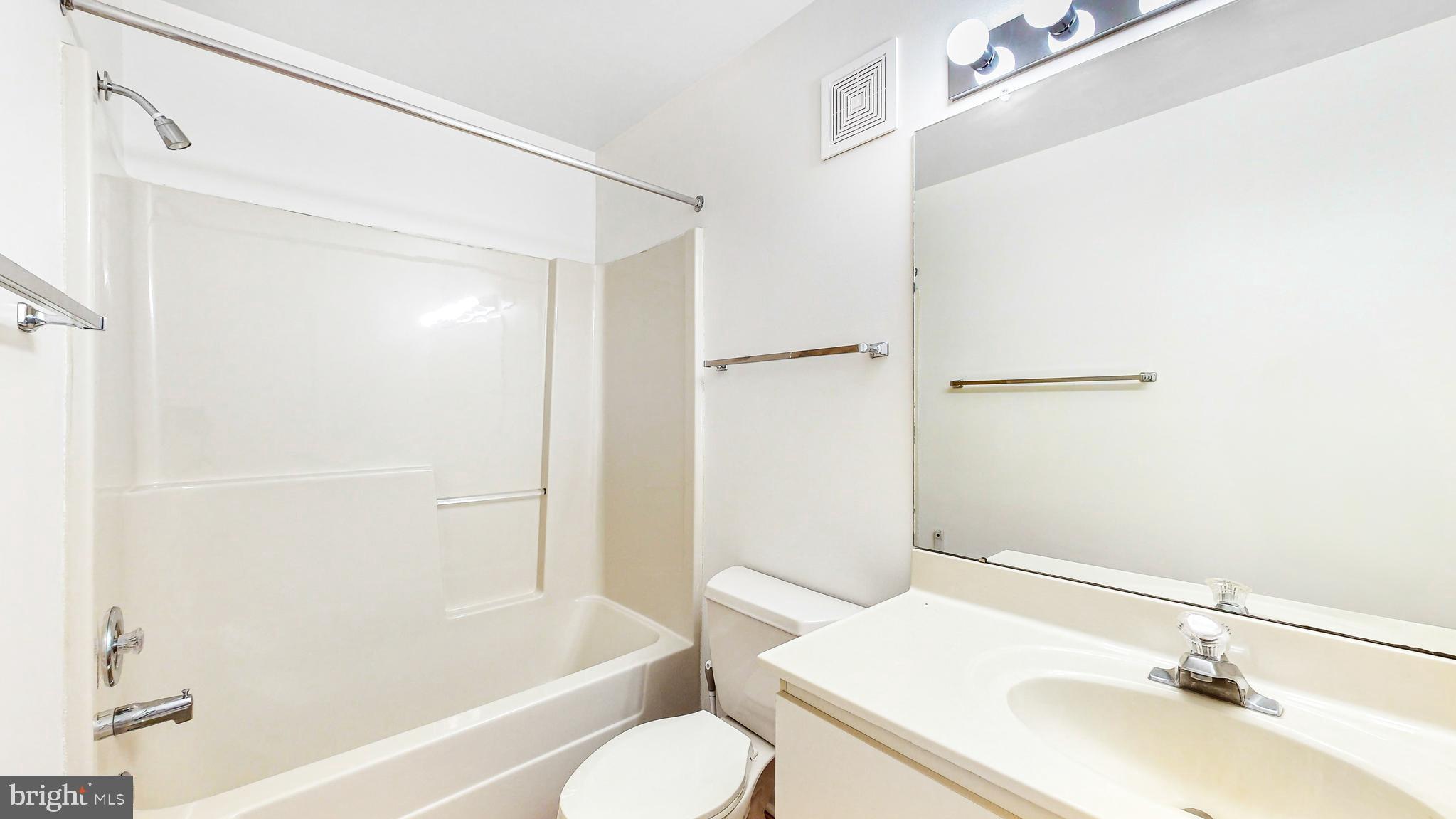 33945 Middleton Circle, Unit 1 Lewes, DE 19958 - Photo 26 of 45 a bathroom with a sink toilet and shower