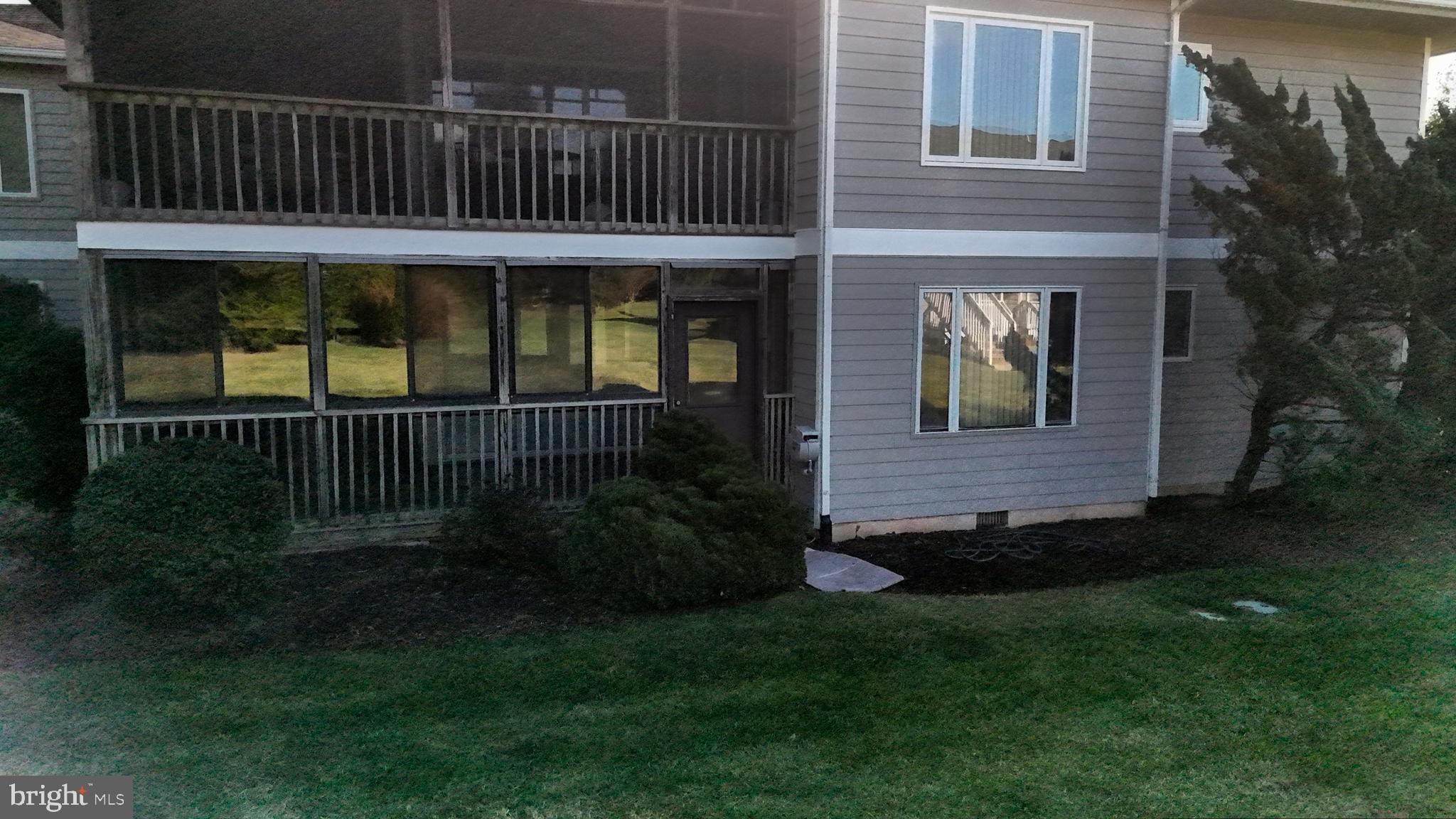 33945 Middleton Circle, Unit 1 Lewes, DE 19958 - Photo 42 of 45 a view of backyard with deck and garden