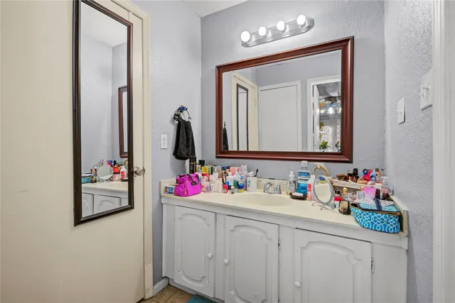 a bathroom with a sink vanity and a mirror