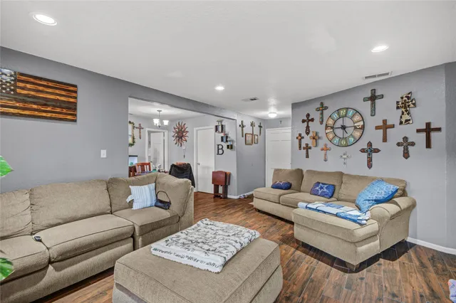 a living room with furniture and wooden floor