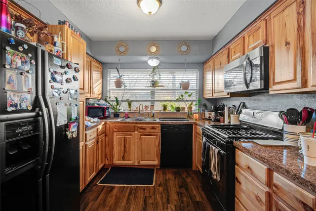 a kitchen with stainless steel appliances granite countertop a stove and a refrigerator