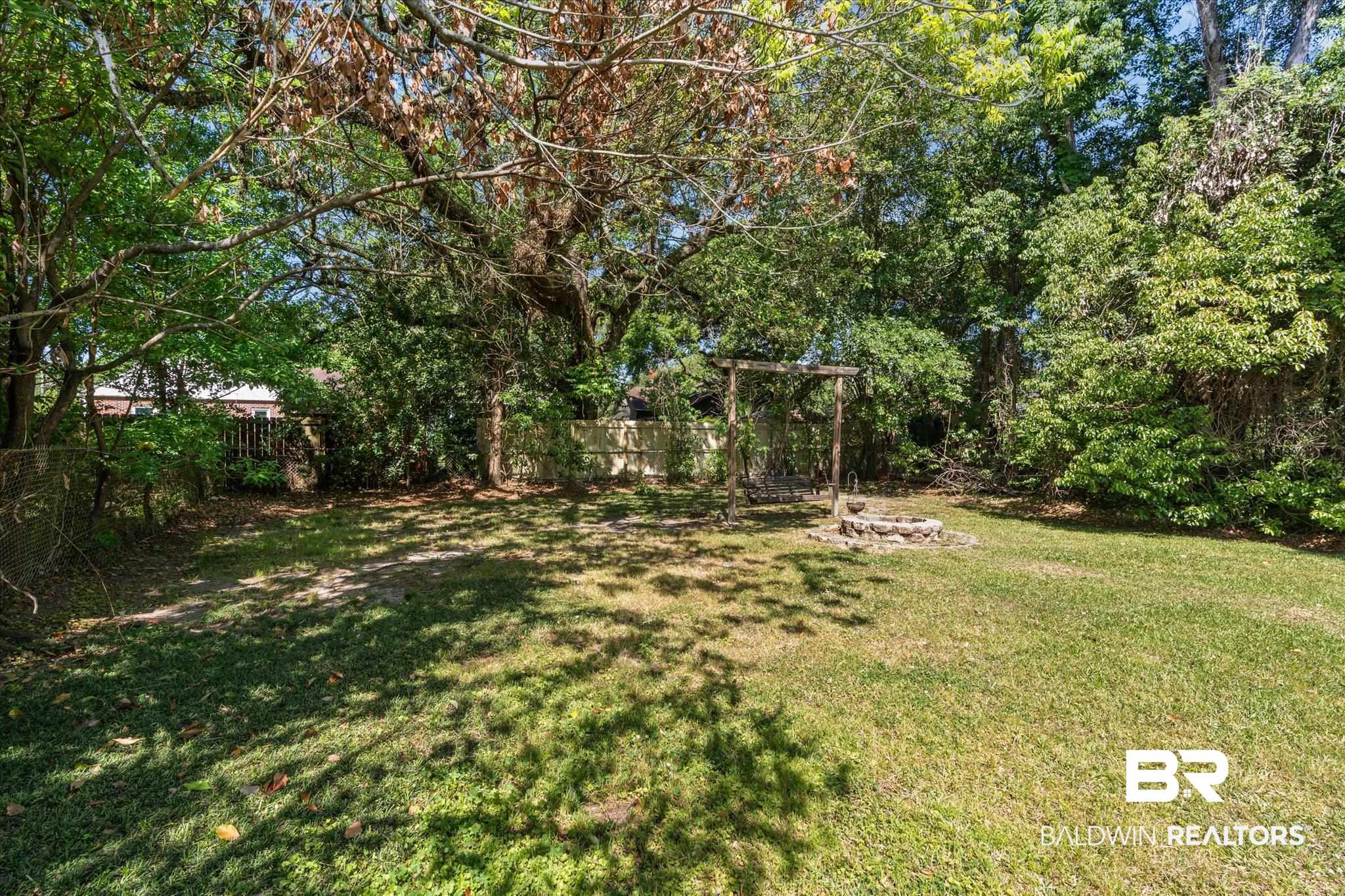 121 North Carlen Street Mobile, AL 36607 - Photo 19 of 21 Fenced backyard with a fire pit