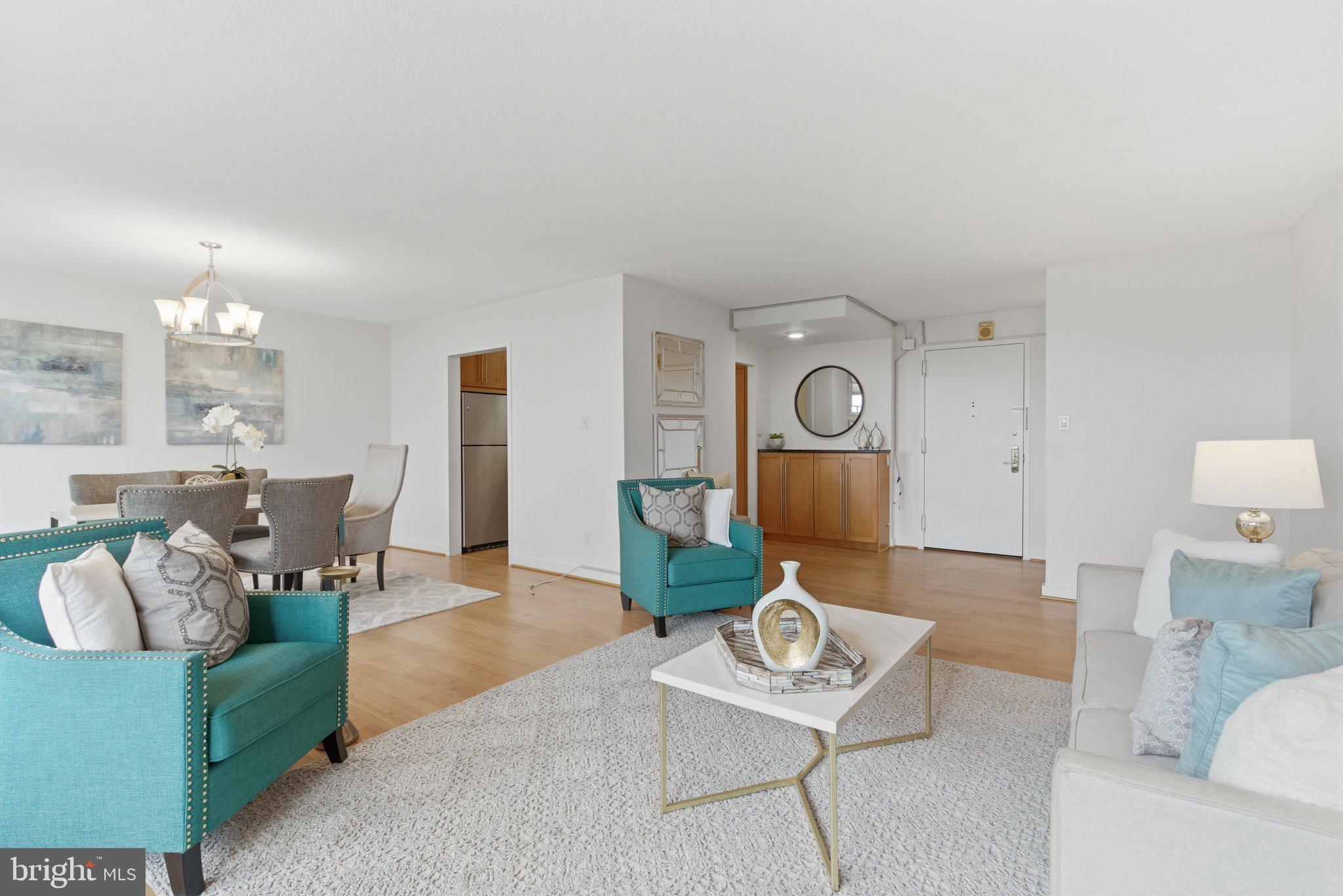5225 Pooks Hill Road, Unit 1323S Bethesda, MD 20814 - Photo 11 of 39 a living room with furniture and a chandelier