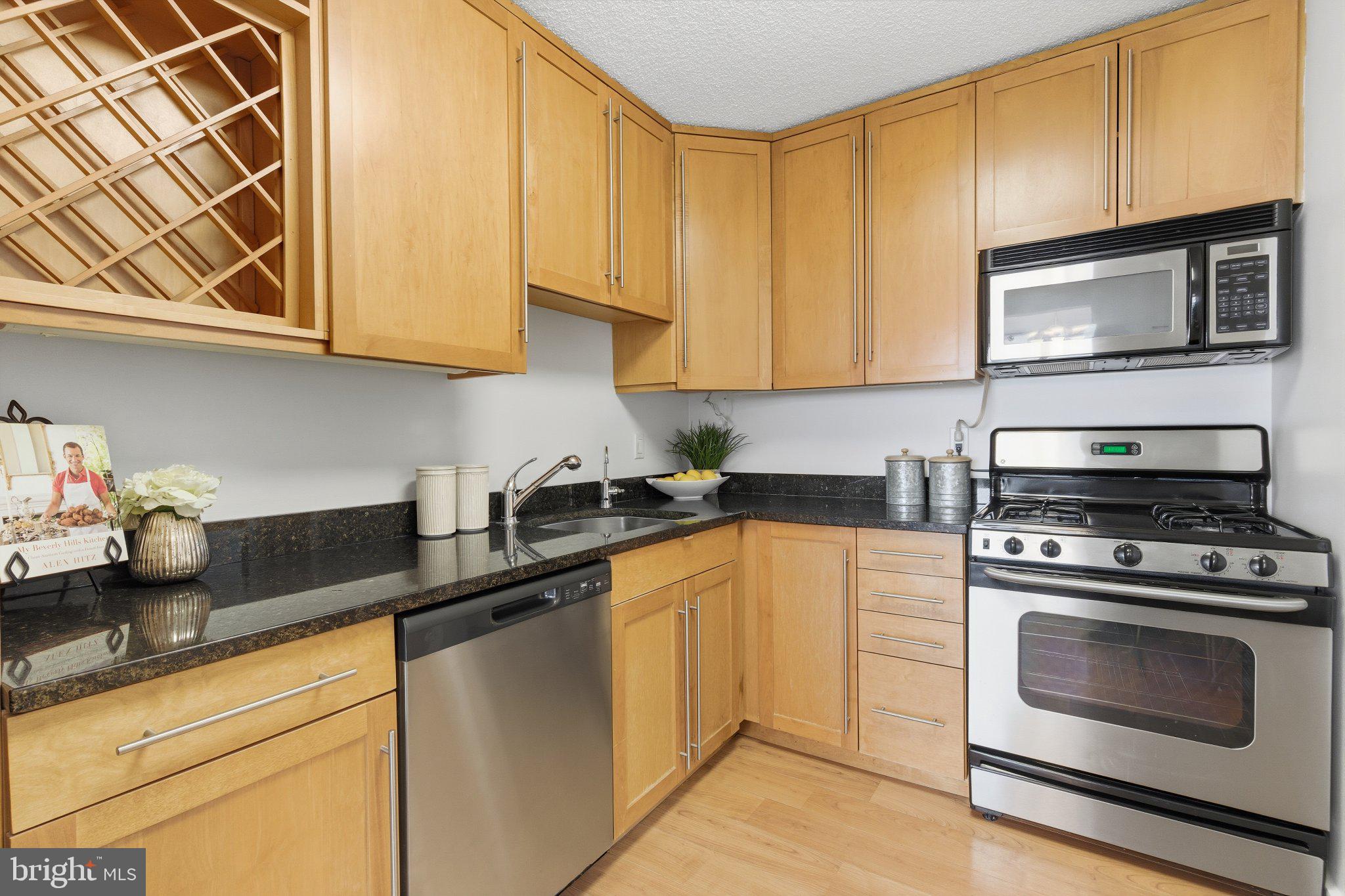 5225 Pooks Hill Road, Unit 1323S Bethesda, MD 20814 - Photo 15 of 39 a kitchen with stainless steel appliances granite countertop a sink a stove a microwave oven and cabinets