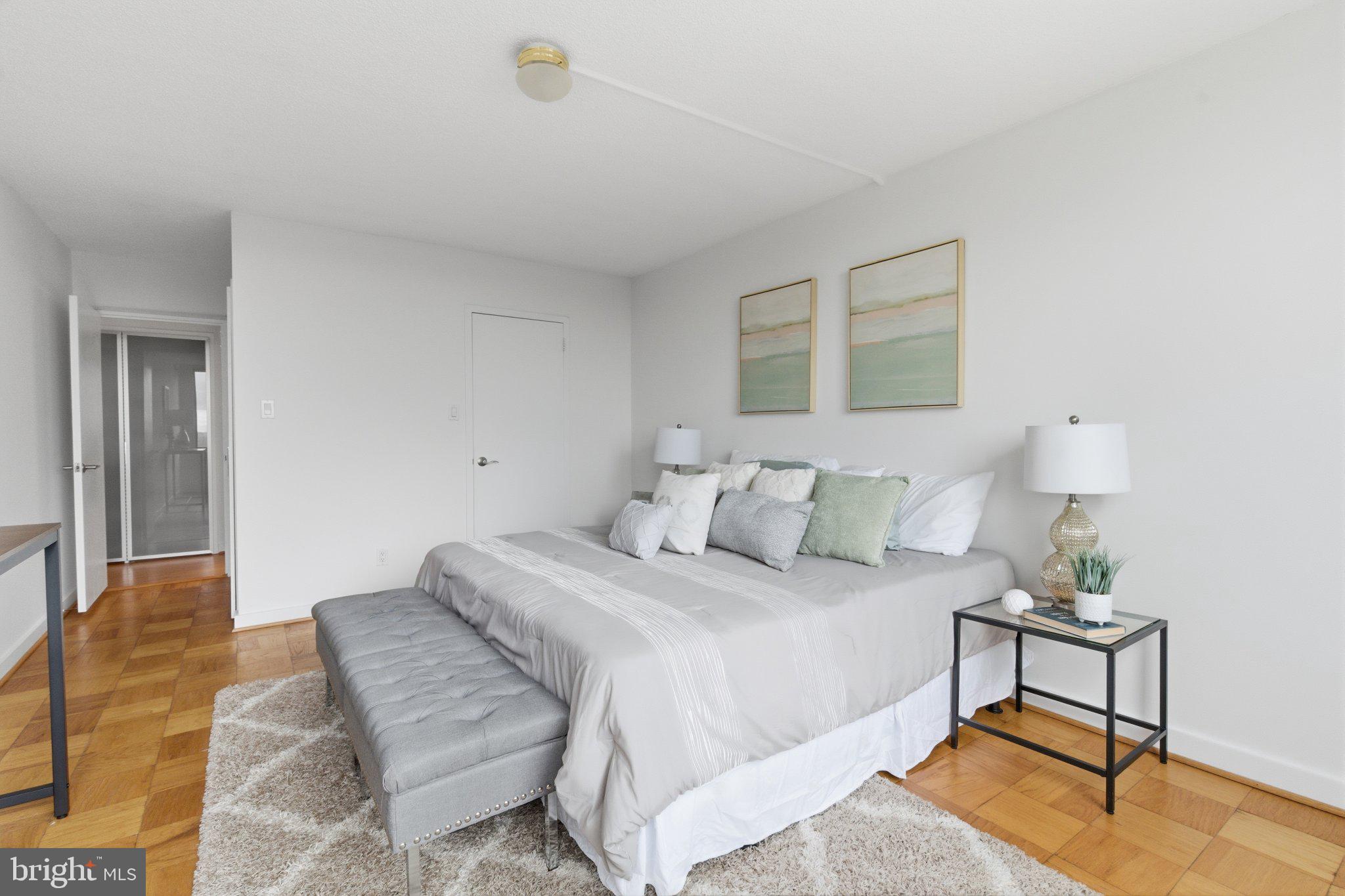 5225 Pooks Hill Road, Unit 1323S Bethesda, MD 20814 - Photo 22 of 39 a bedroom with a bed and a potted plant on table