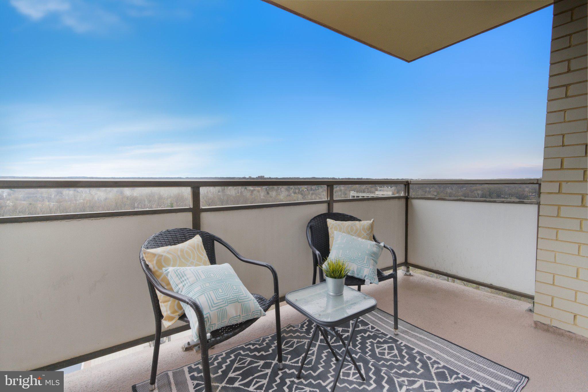 5225 Pooks Hill Road, Unit 1323S Bethesda, MD 20814 - Photo 27 of 39 a balcony with table and chairs