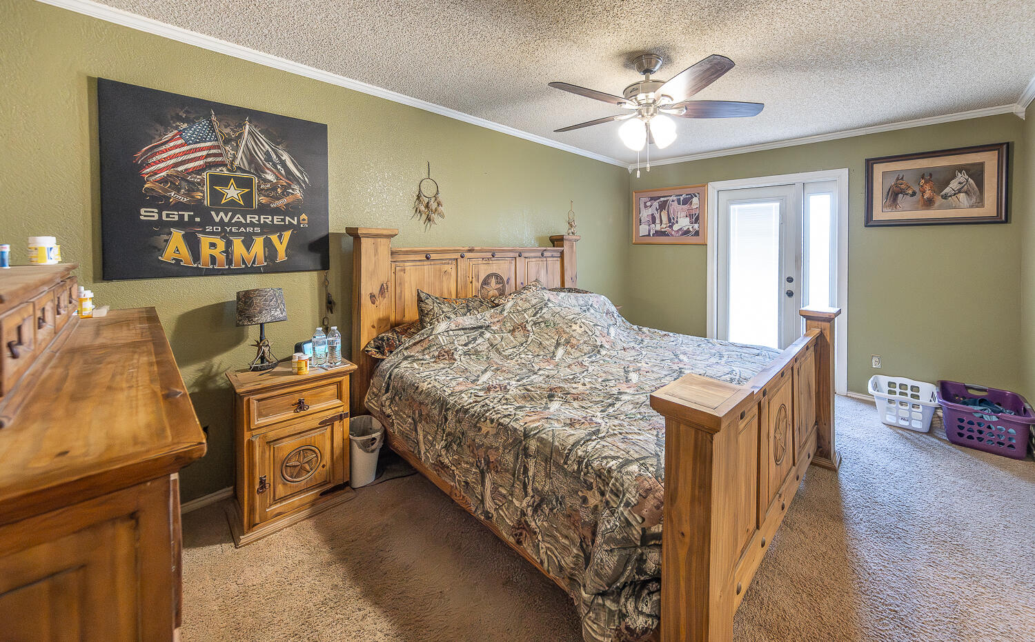 6 Ridge Road Ransom Canyon, TX 79366 - Photo 13 of 31 a bedroom with a bed and a chandelier