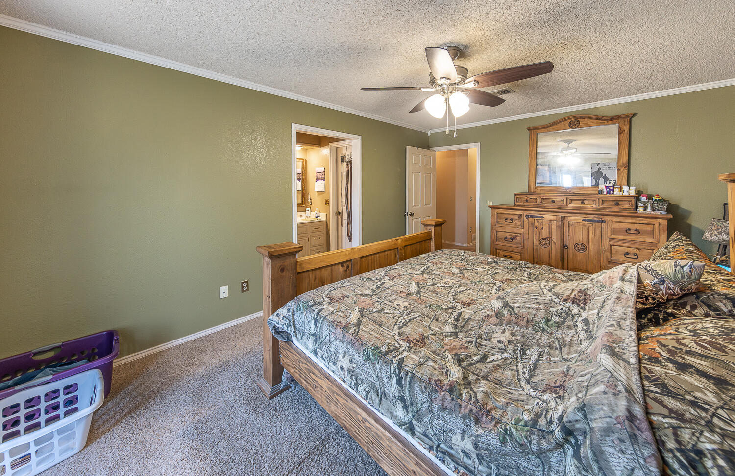 6 Ridge Road Ransom Canyon, TX 79366 - Photo 14 of 31 a bedroom with a bed and a chandelier
