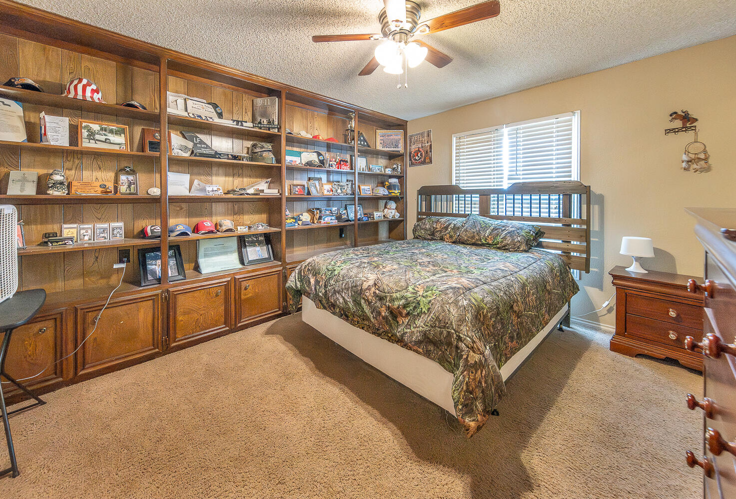 6 Ridge Road Ransom Canyon, TX 79366 - Photo 18 of 31 a bedroom with a large bed and a book shelf