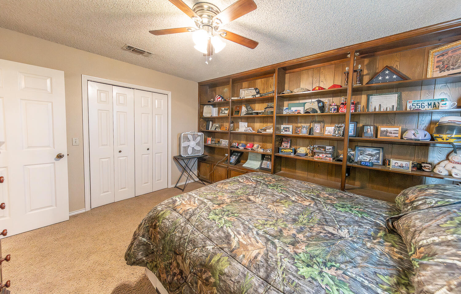 6 Ridge Road Ransom Canyon, TX 79366 - Photo 19 of 31 a bed room with a bed and a book shelf