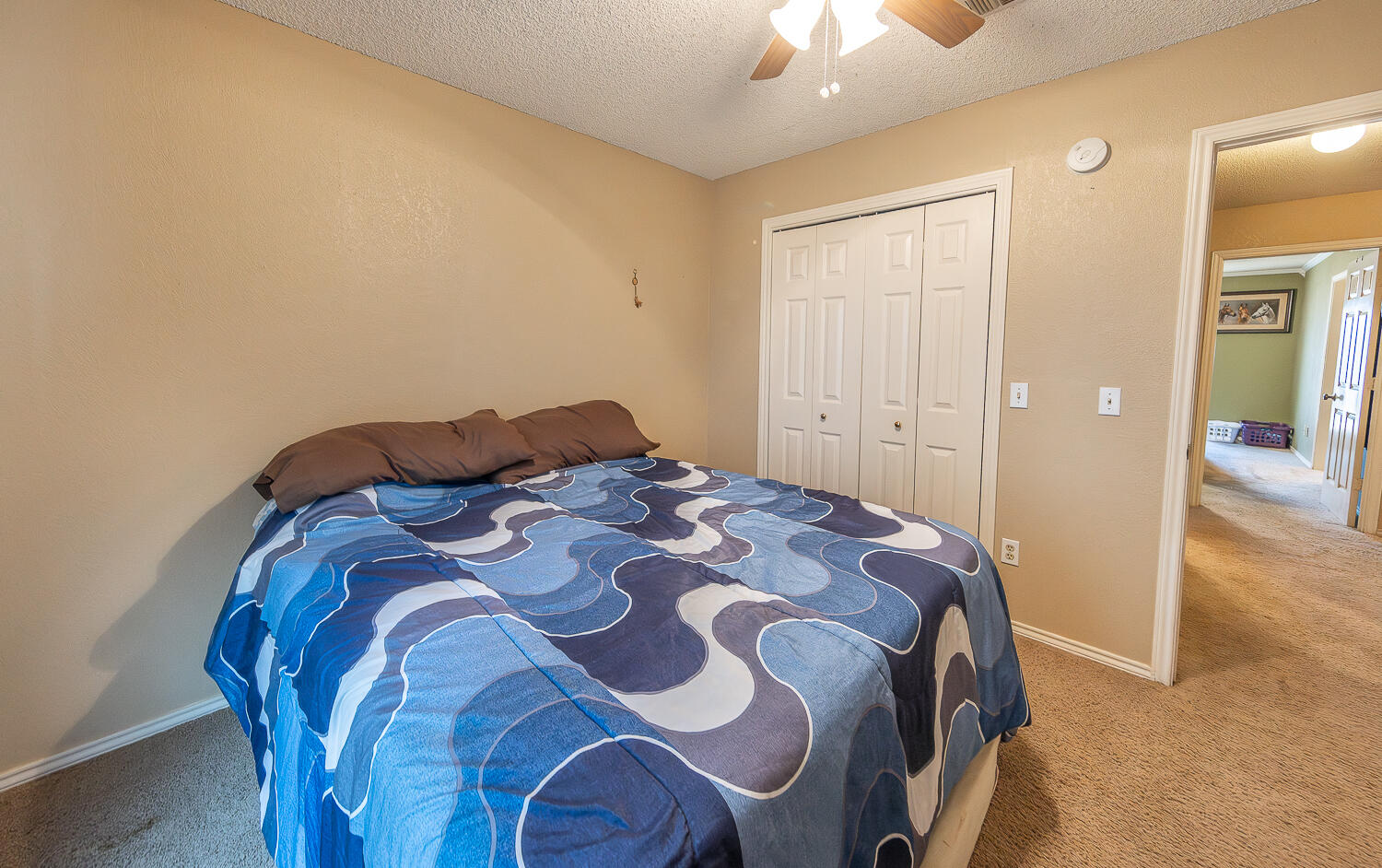 6 Ridge Road Ransom Canyon, TX 79366 - Photo 21 of 31 a bedroom with a bed and a chandelier