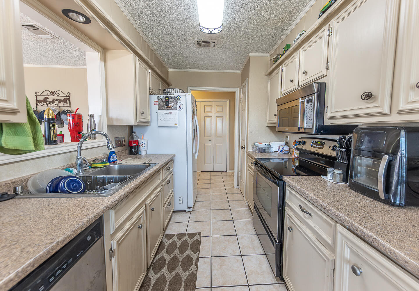 6 Ridge Road Ransom Canyon, TX 79366 - Photo 9 of 31 a kitchen with stainless steel appliances granite countertop a sink stove and refrigerator
