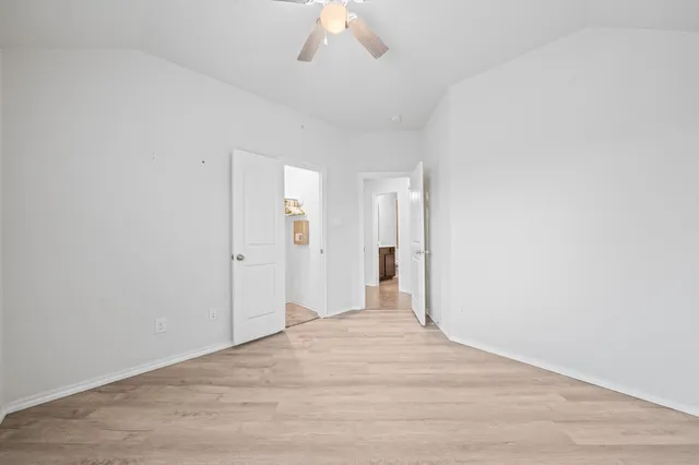 a view of a room with wooden floor