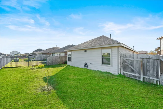 a view of a backyard with plants and a garden