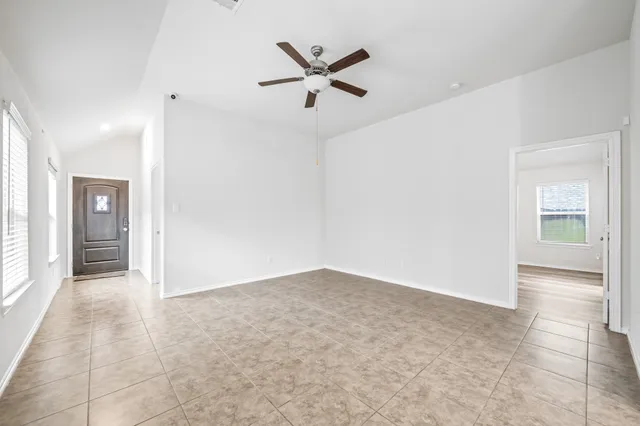 an empty room with closet and ceiling fan