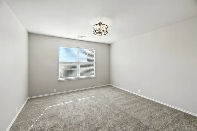 a view of a kitchen with a refrigerator and a window