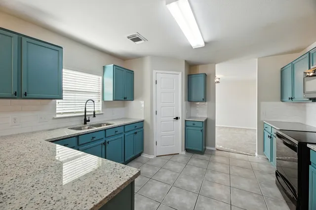 a bathroom with a granite countertop sink toilet and a mirror
