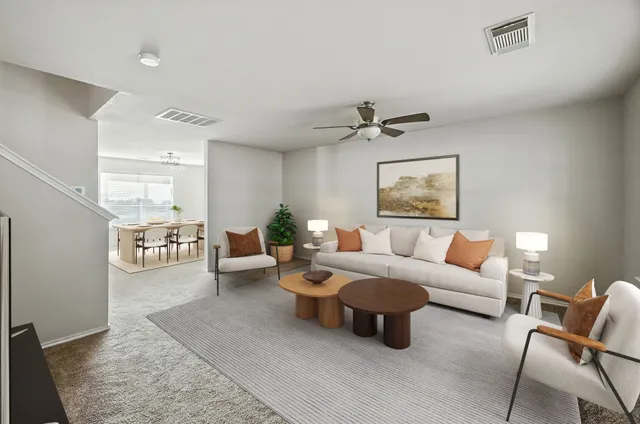 a front view of a house with a yard and trees