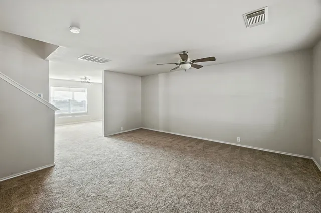 an empty room with windows and pillars in it