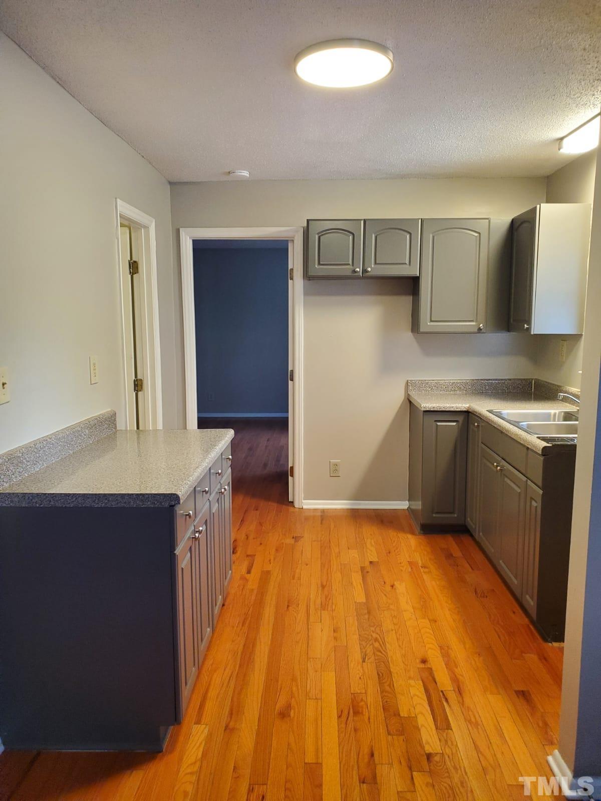 1011 Morreene Road, Unit 11 Durham, NC 27705 - Photo 3 of 5 a kitchen with a sink and cabinets