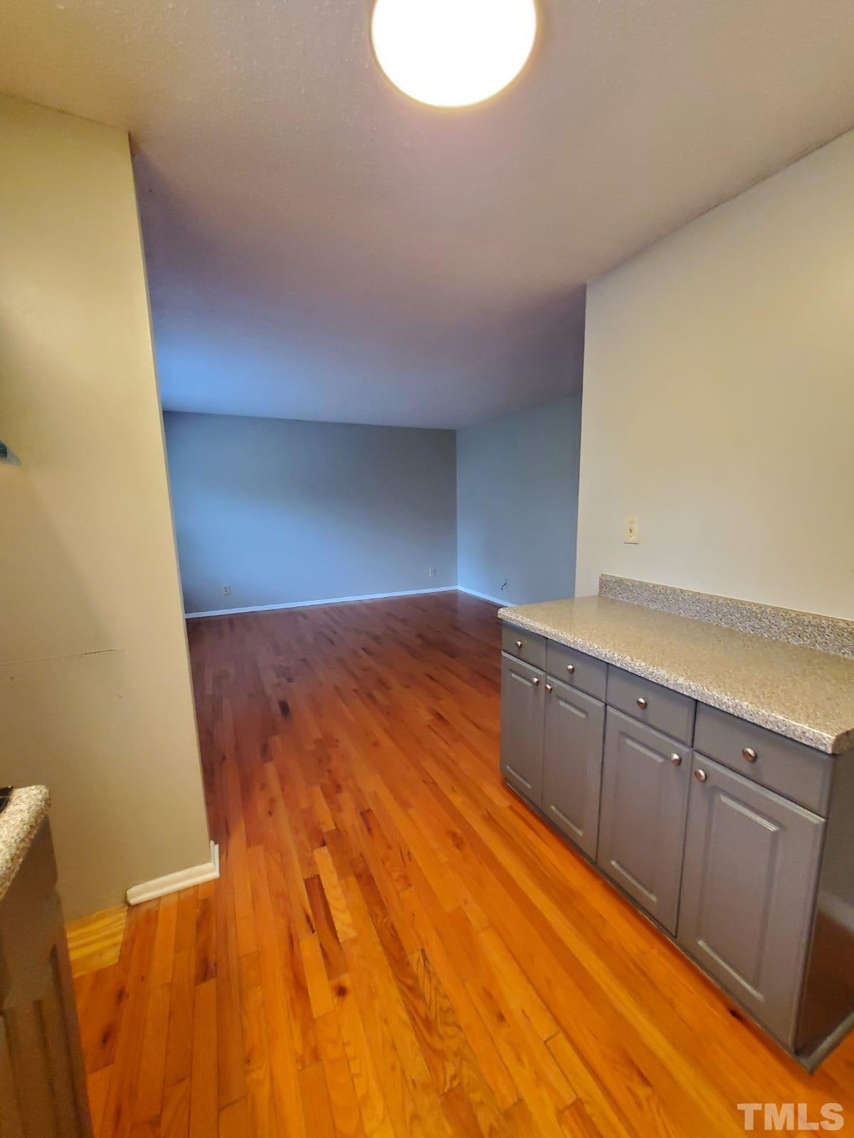 1011 Morreene Road, Unit 11 Durham, NC 27705 - Photo 5 of 5 a view of a room with wooden floor