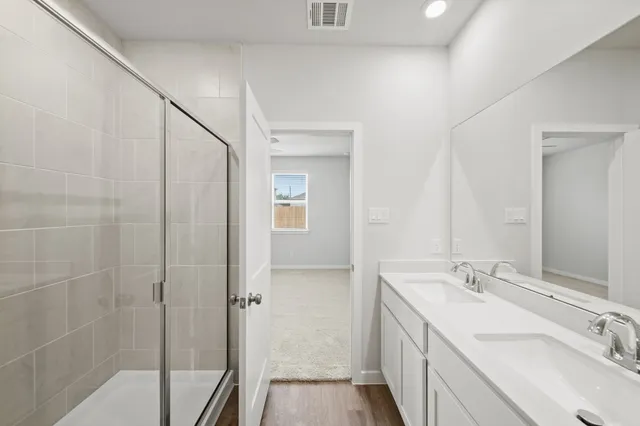 a bathroom with a double vanity sink and mirror
