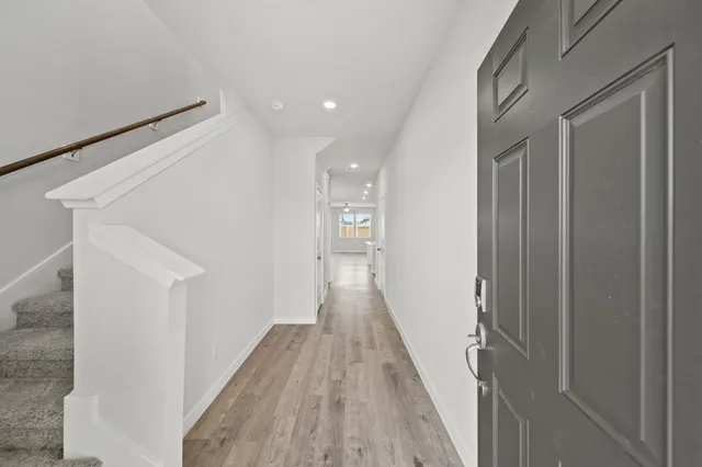 a view of a hallway with wooden floor