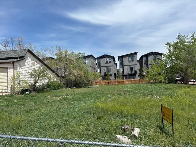 a view of a big house with a big yard and large tree