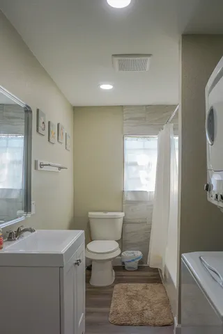 a bathroom with a sink a toilet and mirror