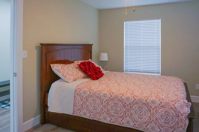 a bedroom with a bed and a window