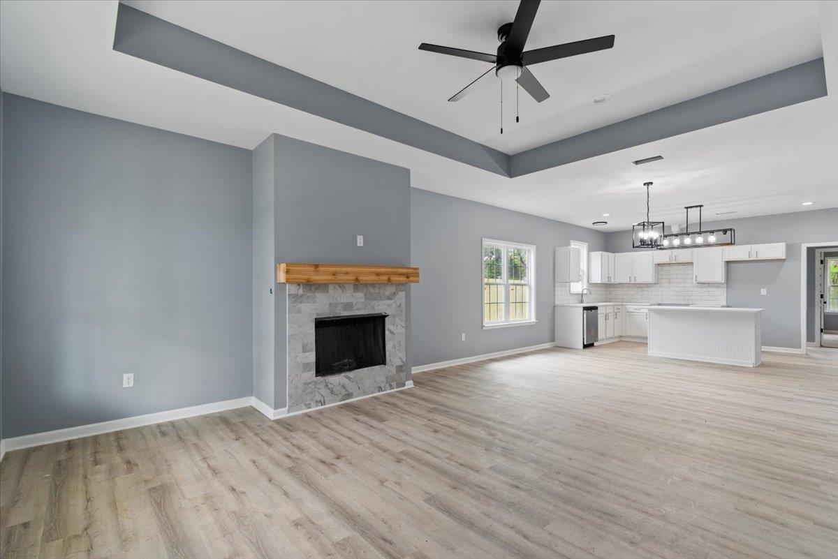 3113 Allison Avenue Memphis, TN 38112 - Photo 5 of 24 a view of a livingroom with a fireplace a ceiling fan and windows