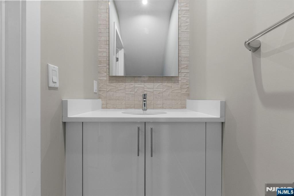 743 Kingsland Avenue, Unit 1 Ridgefield, NJ 07657 - Photo 13 of 27 a bathroom with a sink and a mirror