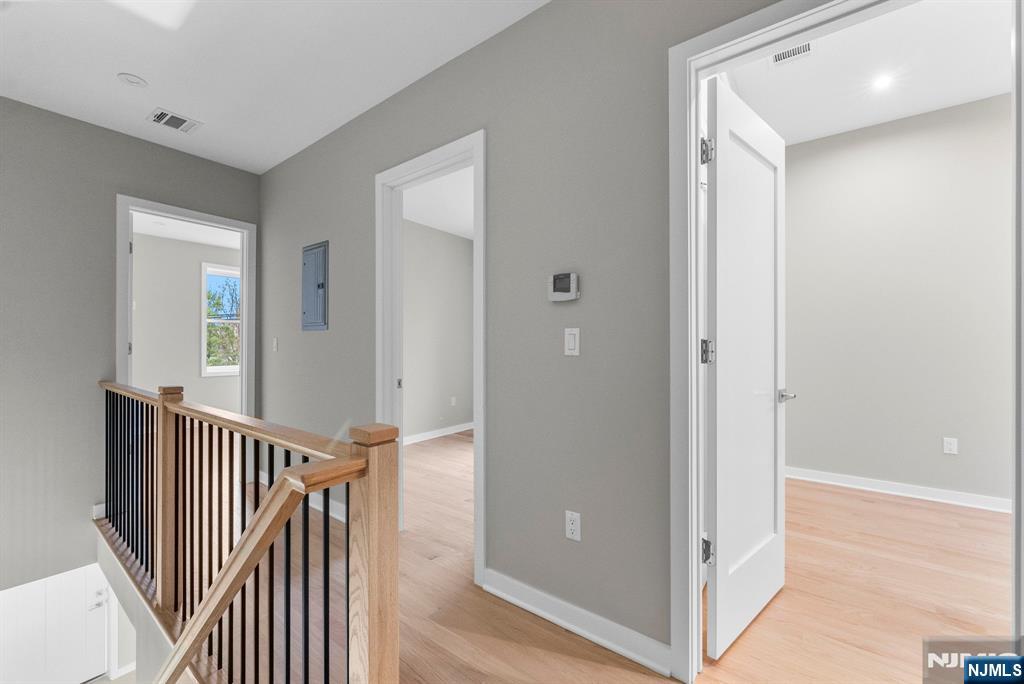 743 Kingsland Avenue, Unit 1 Ridgefield, NJ 07657 - Photo 14 of 27 a view of a hallway with wooden floor and door