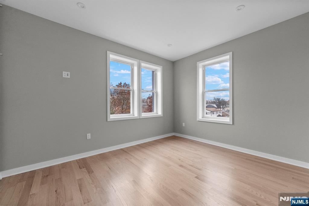 743 Kingsland Avenue, Unit 1 Ridgefield, NJ 07657 - Photo 20 of 27 a view of an empty room with wooden floor and a window