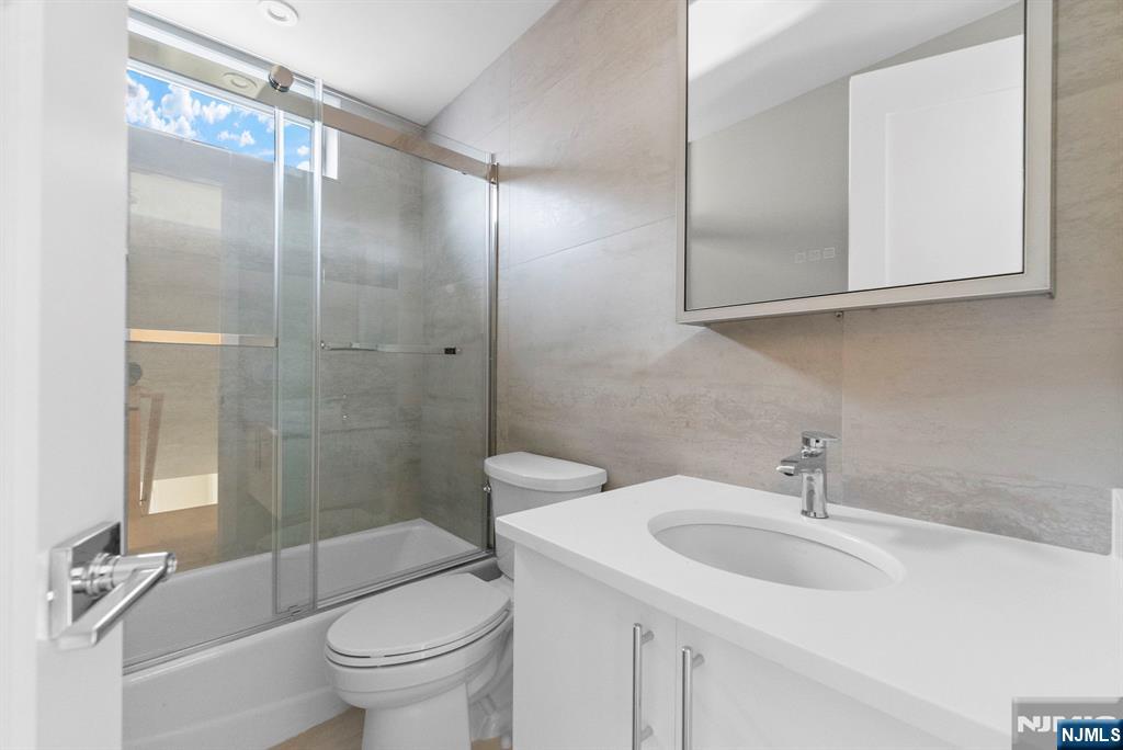 743 Kingsland Avenue, Unit 1 Ridgefield, NJ 07657 - Photo 21 of 27 a bathroom with a sink toilet and shower