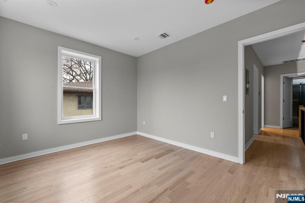 743 Kingsland Avenue, Unit 1 Ridgefield, NJ 07657 - Photo 22 of 27 a view of an empty room with wooden floor and a window