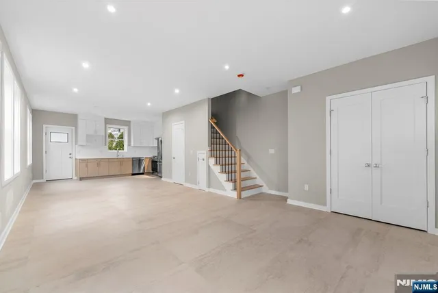 a view of an empty room with stairs and ventilation