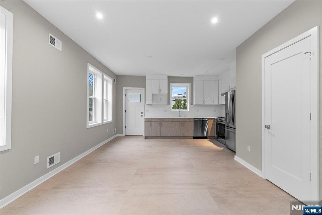 743 Kingsland Avenue, Unit 1 Ridgefield, NJ 07657 - Photo 7 of 27 a view of a big room with windows and chandelier fan